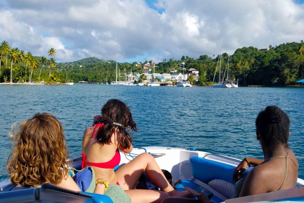 Three ladies enjoying the view of Marigot Bay from the bow of Remedy Speedboat.">